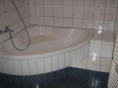 a bath tub with a hose attached to a tiled bathroom at Apartmaji Sparakel in Bled