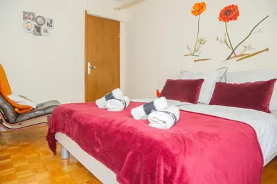 a bedroom with a red bed with towels on it at Apartment Karlie in Rogaška Slatina