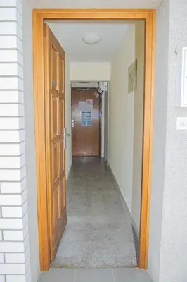 a hallway with a wooden door and a hallwayngth at Apartment Karlie in Rogaška Slatina