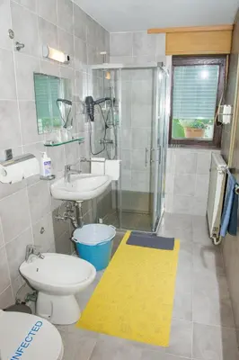 a bathroom with a toilet and a sink and a shower at Apartment Karlie in Rogaška Slatina