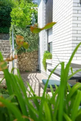a patio with a blue bench in front of a building at Apartment Karlie in Rogaška Slatina