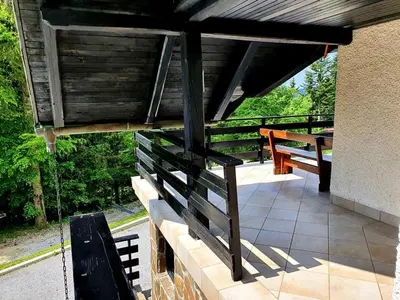 a porch with two benches and a wooden roof at Chalet Anita Rogla in Zreče