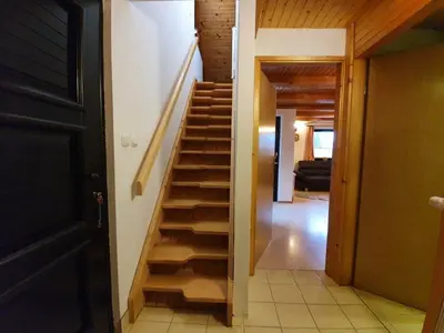 a staircase leading to a room with a living room at Chalet Anita Rogla in Zreče