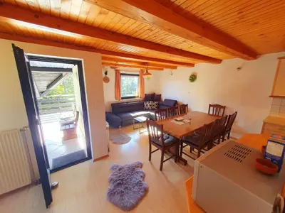 a living room with a table and a dining room at Chalet Anita Rogla in Zreče