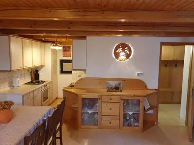 a kitchen with a wooden island in the middle at Chalet Anita Rogla in Zreče