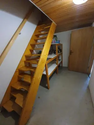 a wooden staircase in a room with a door at Chalet Anita Rogla in Zreče