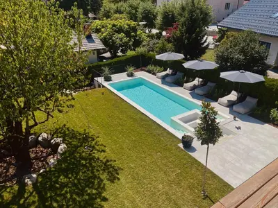 an overhead view of a swimming pool in a yard with umbrellas at Villa Pomona in Bled