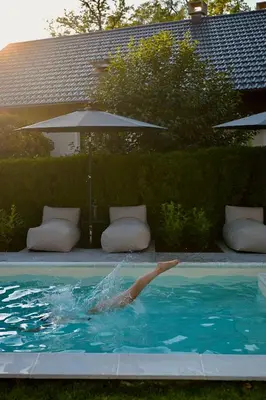 a person in a swimming pool in the water at Villa Pomona in Bled
