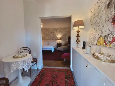 a room with a bedroom with a bed and a table at Villa Pomona in Bled