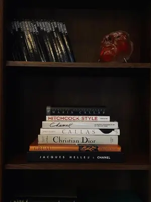 a stack of books sitting on a shelf at Villa Pomona in Bled