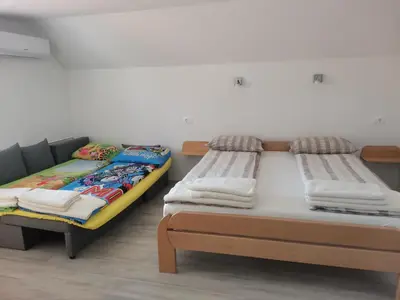 two beds sitting next to each other in a room at APARTMAJI HUBI in Bled