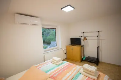 a bedroom with a bed and a window at APARTMAJI HUBI in Bled