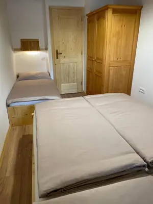 a bedroom with two beds and a closet at Apartma Korošec in Srednja Vas v Bohinju