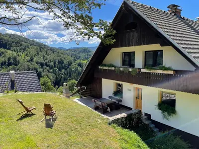 a house on top of a hill with a view at Apartma Korošec in Srednja Vas v Bohinju