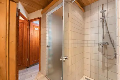 a shower with a glass door in a bathroom at Tonkina koča in Kranjska Gora
