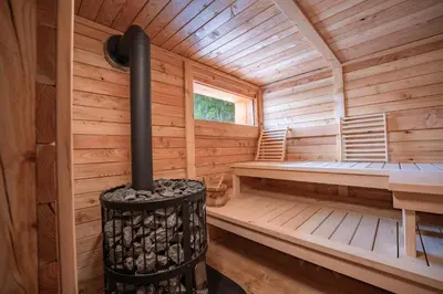 a wooden sauna with a fireplace in a cabin at Tonkina koča in Kranjska Gora