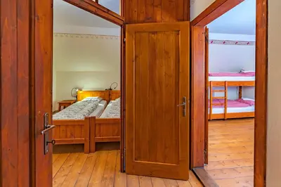an open door to a bedroom with two bunk beds at Tonkina koča in Kranjska Gora