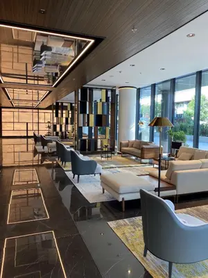 a lobby with couches and chairs in a building at Grand Plaza Hotel & Congress Center in Ljubljana