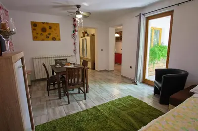 a kitchen and dining room with a table and chairs at Apartma Pic Ros in Kojsko