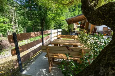 two wooden benches sitting next to a fence at Apartma pri lipi in Bohinj