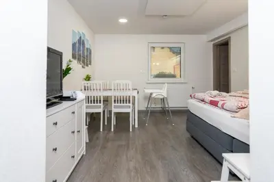 a bedroom with a bed and a table and chairs at Apartma pri lipi in Bohinj