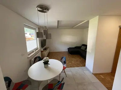 a living room with a white table and a couch at Pod Galetovcem in Bohinjska Bela