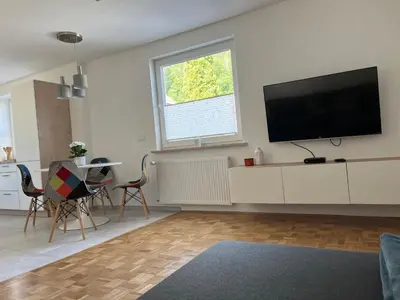 a living room with a flat screen tv on a wall at Pod Galetovcem in Bohinjska Bela
