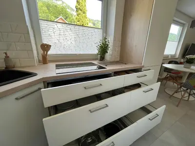 a kitchen with white drawers and a sink at Pod Galetovcem in Bohinjska Bela