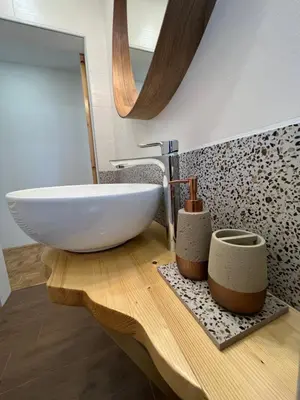 a bathroom with a white sink on a wooden table at Pod Galetovcem in Bohinjska Bela