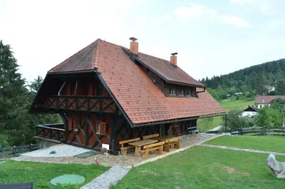 a large wooden building with a red roof at Posestvo Brinje in Gradiček