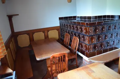 a restaurant with wooden tables and chairs and a bar at Posestvo Brinje in Gradiček