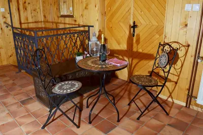 a small table and two chairs in a room at Posestvo Brinje in Gradiček