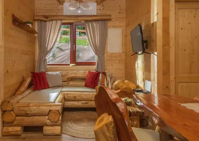 a living room with a couch and a window at Lake Cottage - Koča ob jezeru in Nazarje