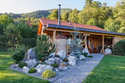 a house with a garden in front of it at Lake Cottage - Koča ob jezeru in Nazarje