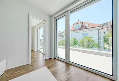 an empty living room with sliding glass doors at Apartments Trnovo in Ljubljana