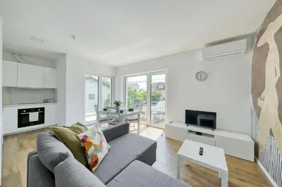 a living room with a couch and a table at Apartments Trnovo in Ljubljana