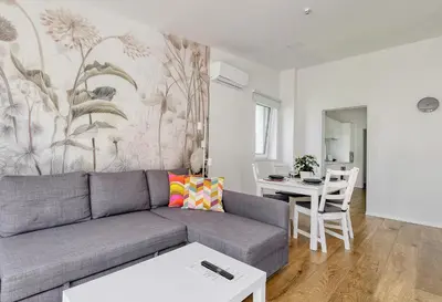 a living room with a couch and a table at Apartments Trnovo in Ljubljana