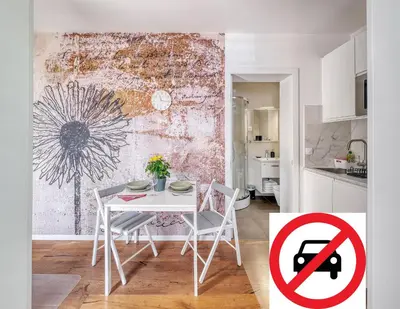 a white table and chairs in a kitchen with a no parking sign at Apartments Trnovo in Ljubljana