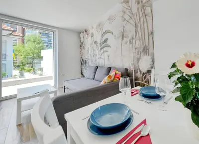a living room with a couch and a table at Apartments Trnovo in Ljubljana
