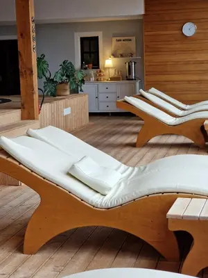 a group of chairs sitting on top of a wooden floor at Guesthouse Jelenov greben in Podčetrtek