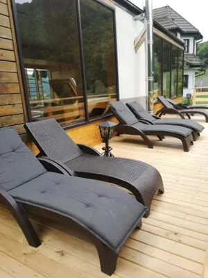 a row of chairs sitting on a deck at Guesthouse Jelenov greben in Podčetrtek