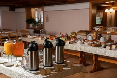 a table with two silver spousanders on it at Guesthouse Jelenov greben in Podčetrtek