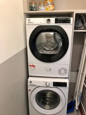 a washing machine and a dryer in a room at Riverside apartment in Ljubljana