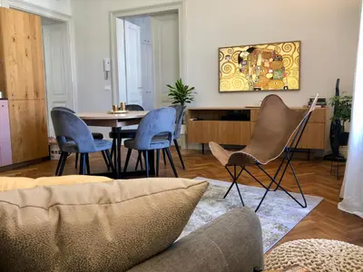 a living room with a table and chairs at Riverside apartment in Ljubljana