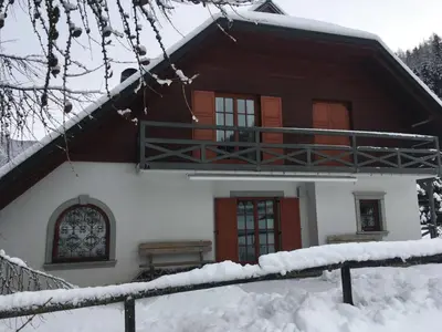 a house in the snow with a fence in front at Villa Dona in Kranjska Gora