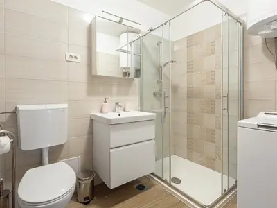 a bathroom with a toilet sink and a shower at Apartma Vrtnica 5th floor in Nova Gorica