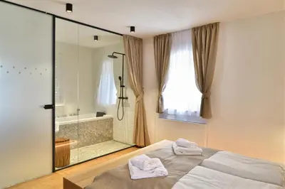 a bedroom with a bed and a shower and a tub at Hisa 1624 - Adults Only in Zgornja Kungota