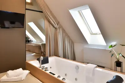 a bathroom with a bath tub with a large mirror at Hisa 1624 - Adults Only in Zgornja Kungota