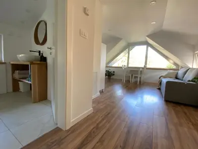 a living room with a couch and a table at Apartment Židana marela - Attic with a View in Kranjska Gora