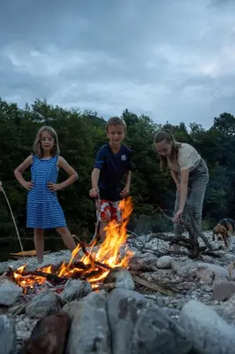 a group of children standing around a fire at Riverside Villa Avo - Apartment Sara in Spodnja Idrija